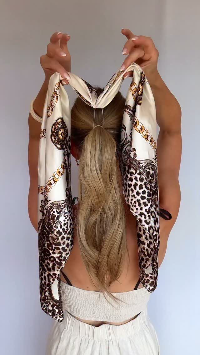 8 Simple Half Up Hairstyles for Every Occasion 8 Blonde woman tying a leopard print scarf around a half-up ponytail hairstyle.