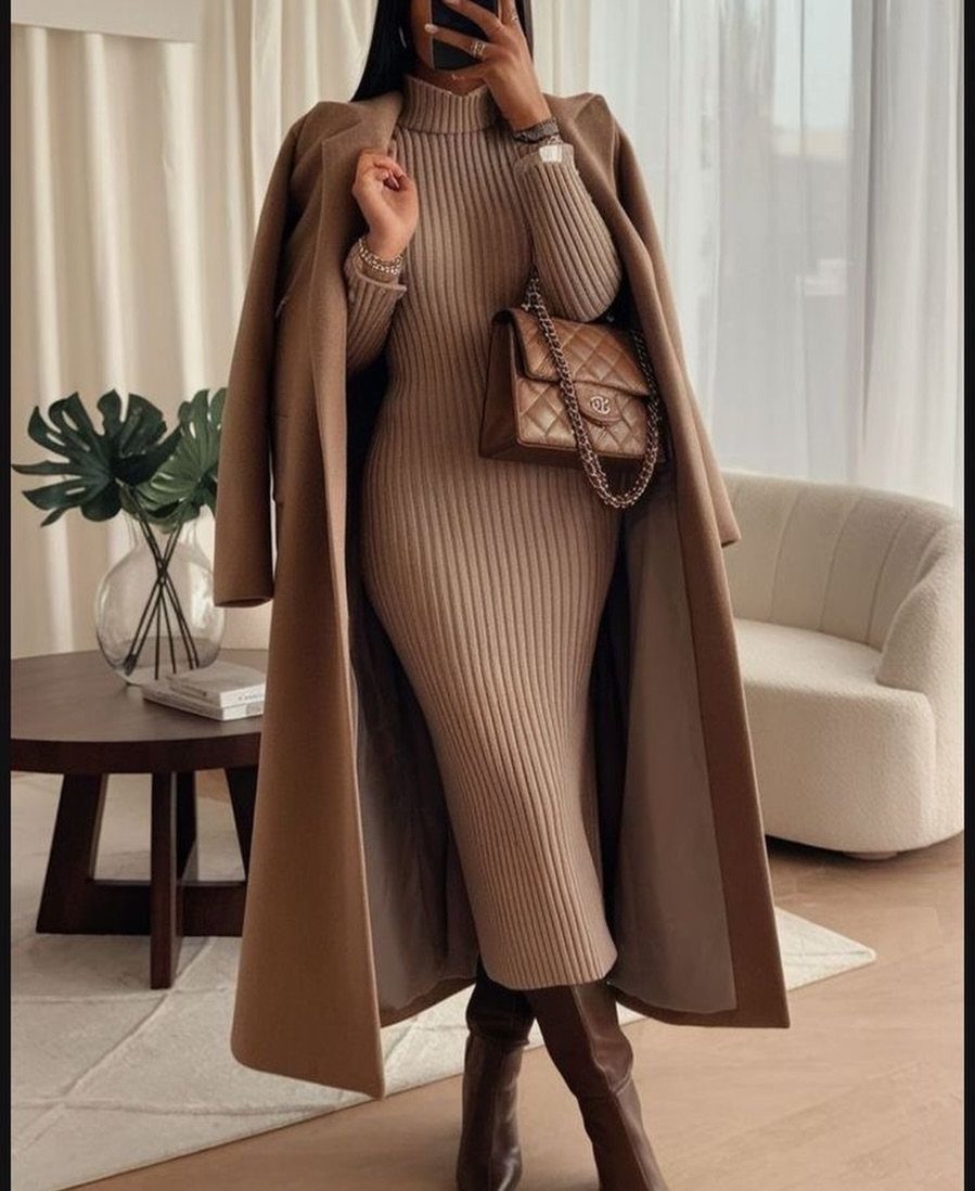 Woman in a tan ribbed knit dress and brown slouchy leather boots.