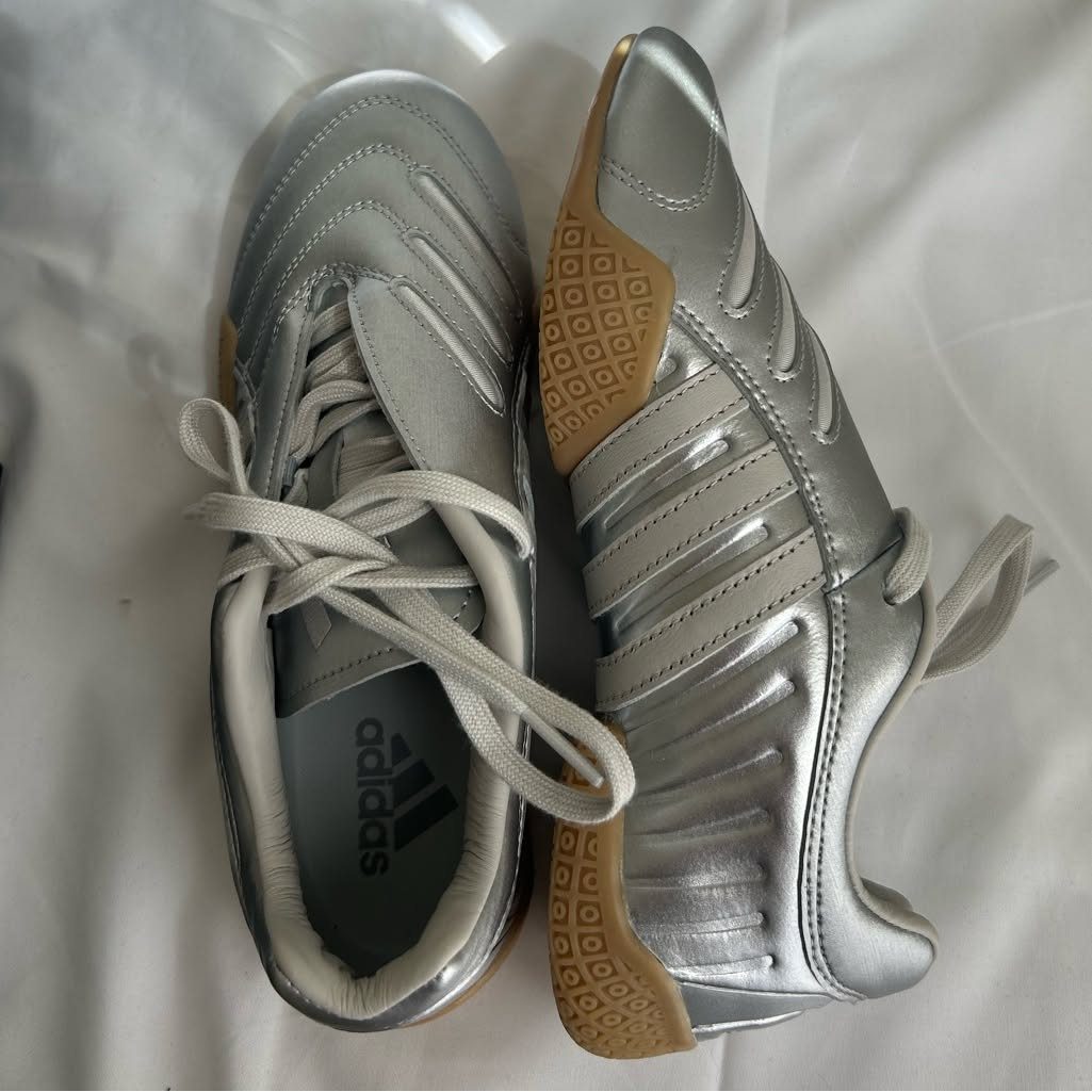 Silver metallic Adidas taekwondo lace shoes with gum rubber soles on white fabric