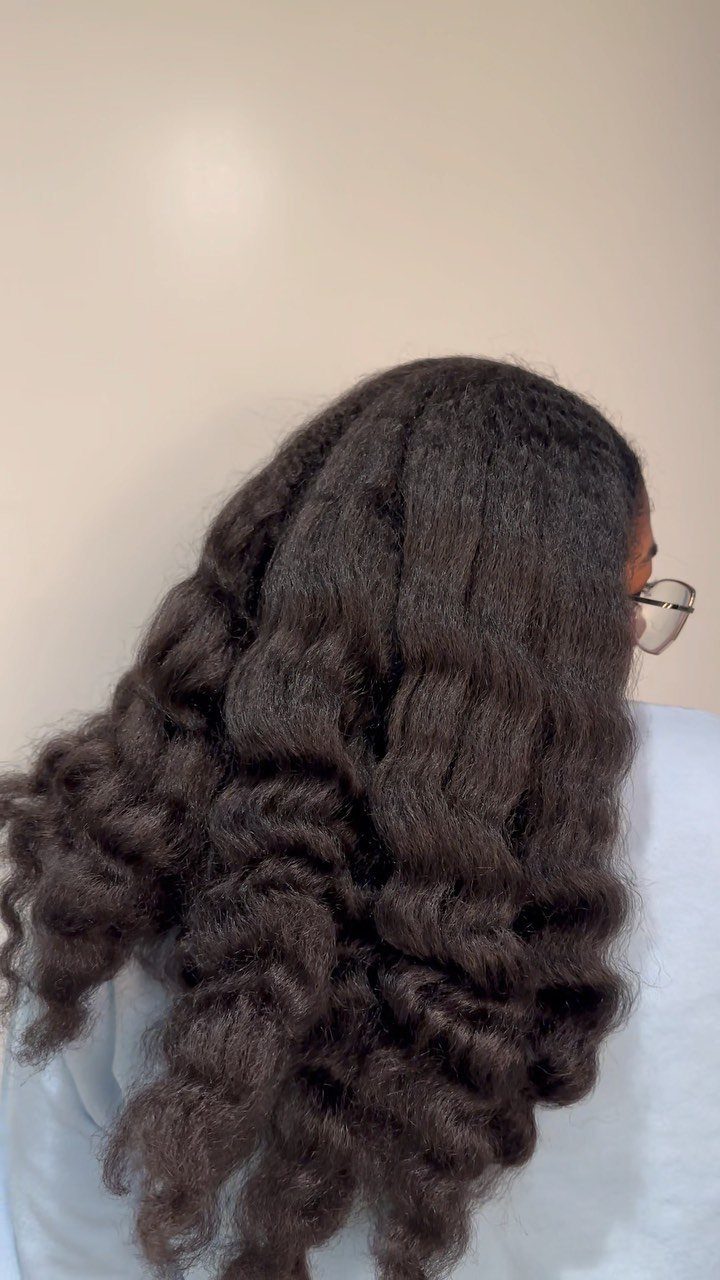6 Twist Outs on 4c Hair Ideas for Every Look and Length 2 Voluminous chunky twist-outs on long dark 4c hair against a plain wall.