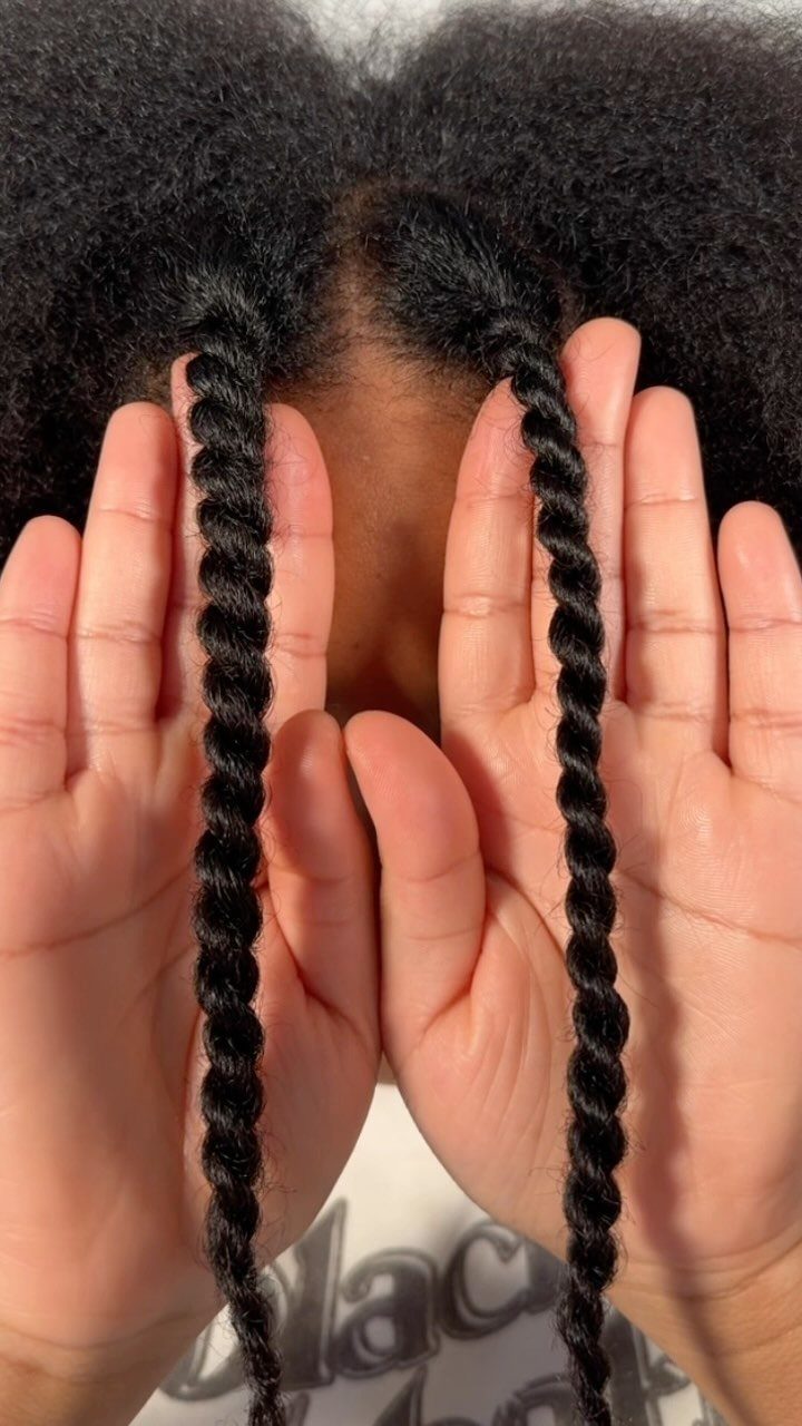 6 Twist Outs on 4c Hair Ideas for Every Look and Length 4 Two tightly twisted sections of black 4c hair held up by hands.