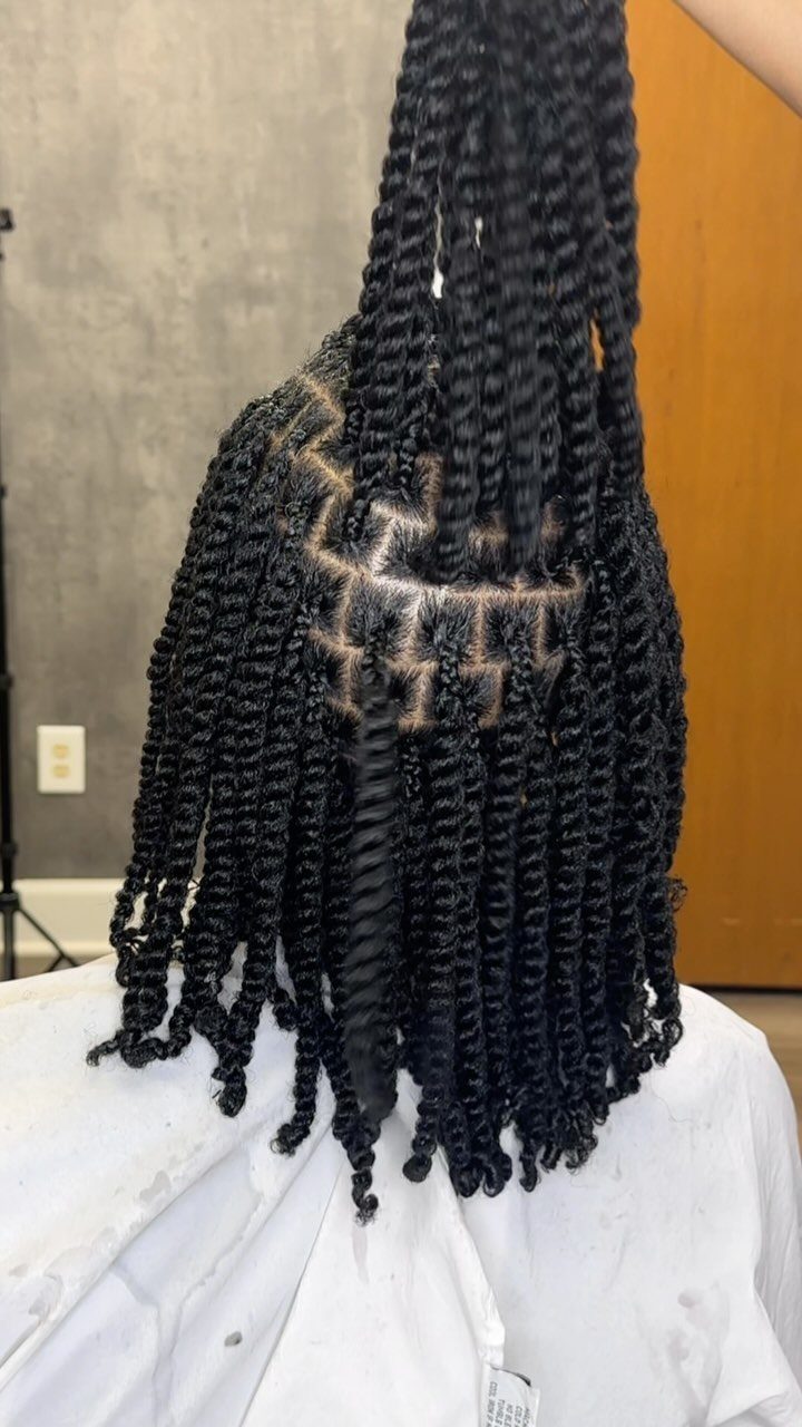 Two Strand Twist Natural Hair Women: 10 Style Ideas 2 Black natural hair styled in two-strand twists with a section lifted upward.