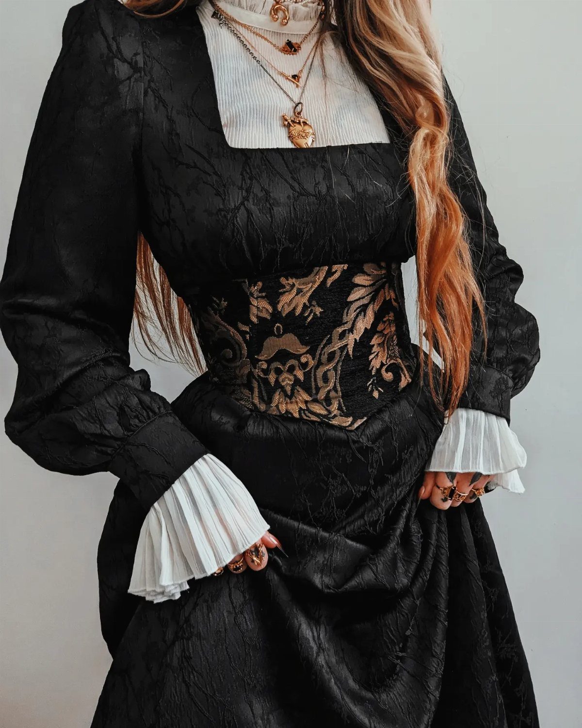 Victorian Era Sleeves: 6 Styles From Puffed to Bell 6 Victorian black dress with gold corset and layered white pleated sleeve ruffles