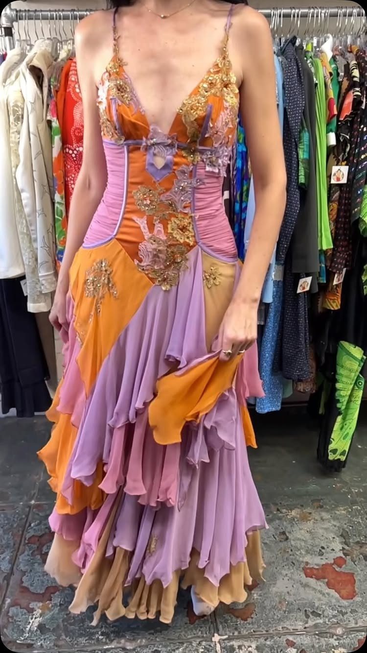 Vintage Runway Dresses: 5 Ideas from Versace to Slip Styles 2 Woman wearing a colorful vintage gown with orange and purple tiered ruffles.