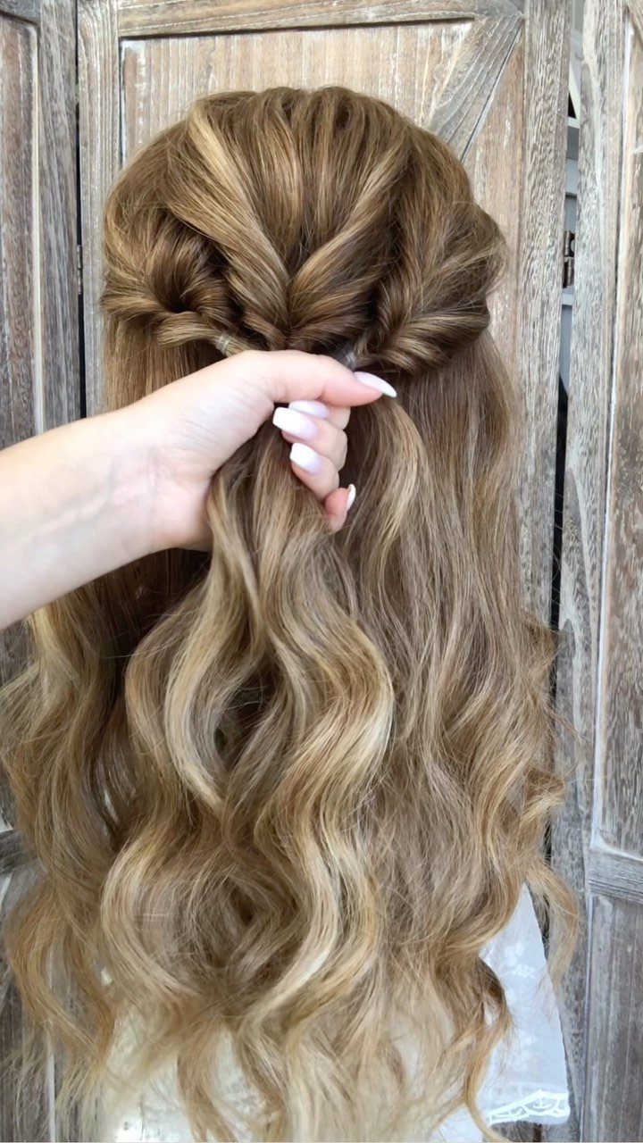Long honey-blonde wavy hair styled in a romantic twisted half-updo from behind.