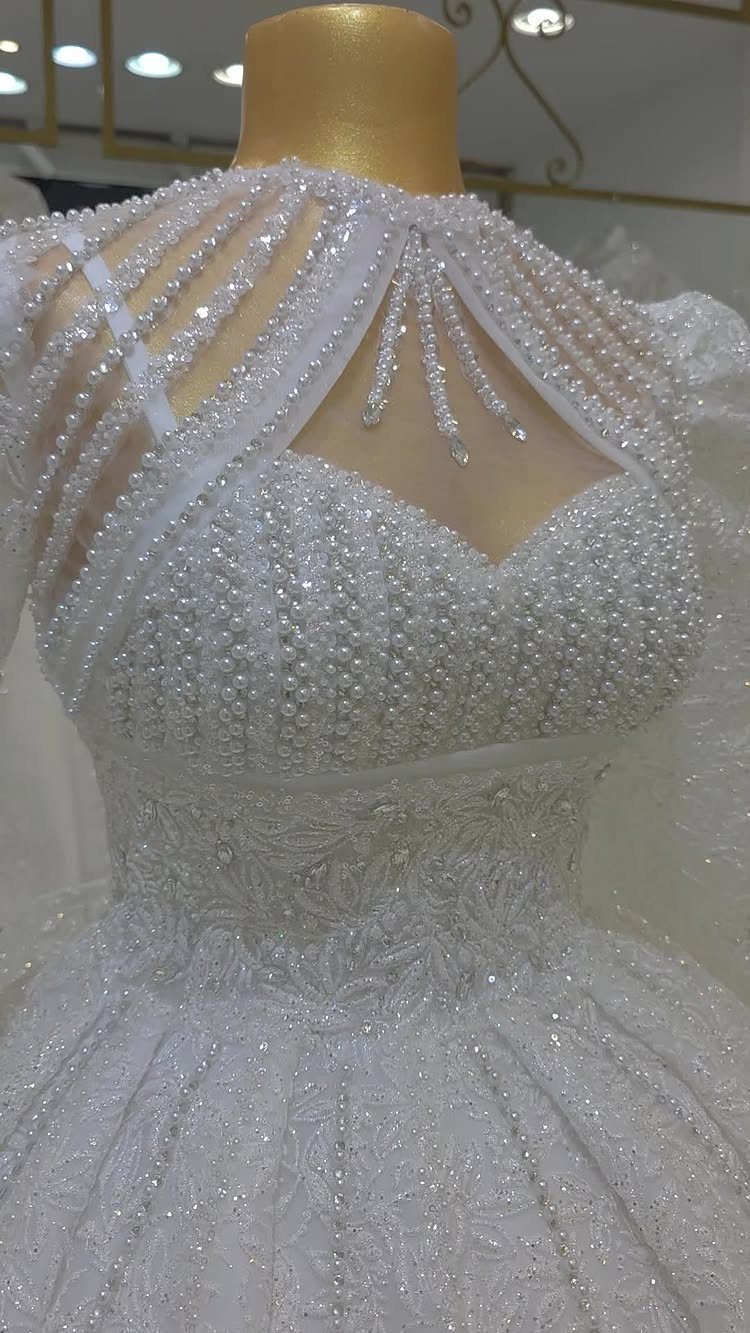 Wedding Dresses Off White: 9 Ideas for Every Bride 5 Off-white bridal gown with intricate beading and lace on a gold mannequin