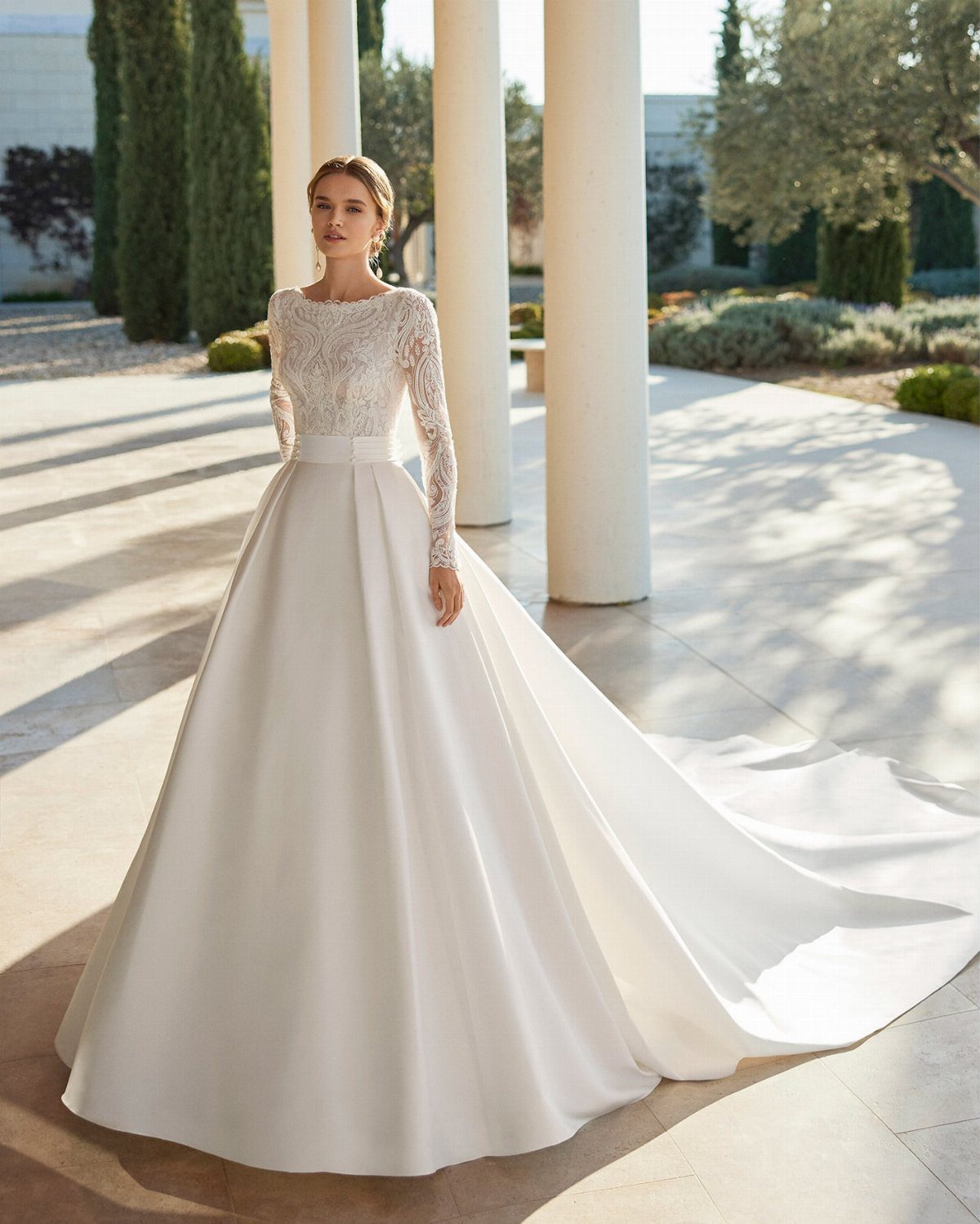 Wedding Dresses Off White: 9 Ideas for Every Bride 9 Woman in an off-white wedding dress with lace bodice and full satin skirt.