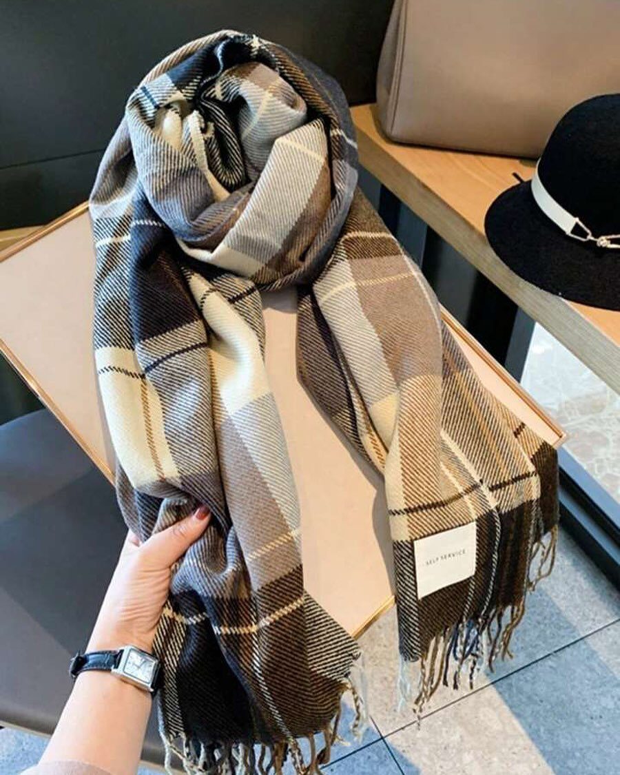 13 Winter Wear Ideas for Women: Coats, Knits and Boots 2 Plaid brown and beige scarf with fringed edges held by a hand.