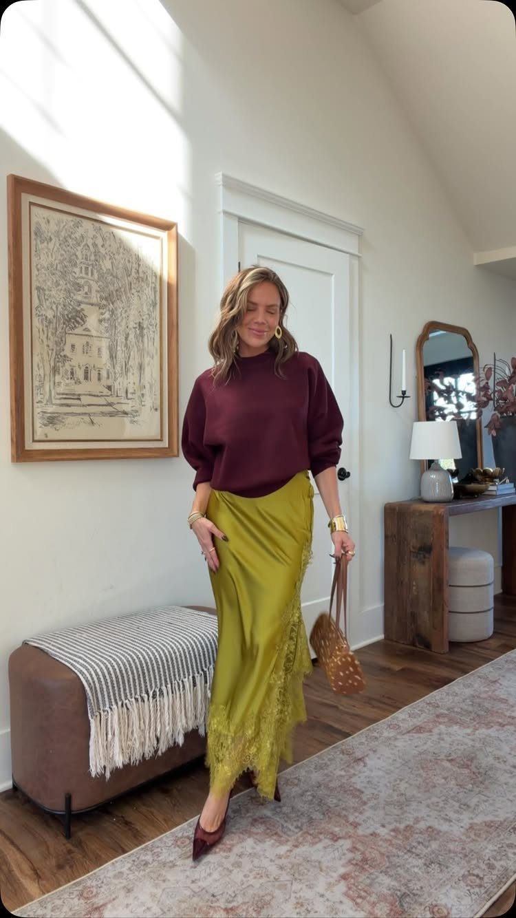 14 Women Skirt Outfits for Every Season and Occasion 1 Woman wearing a burgundy sweater and a long lime green satin maxi skirt.
